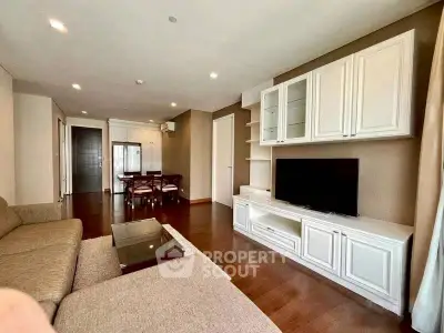 Spacious living room with elegant furniture and modern decor in a stylish apartment.