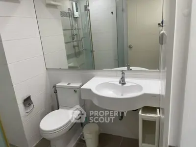 Modern bathroom with sleek fixtures and glass shower enclosure