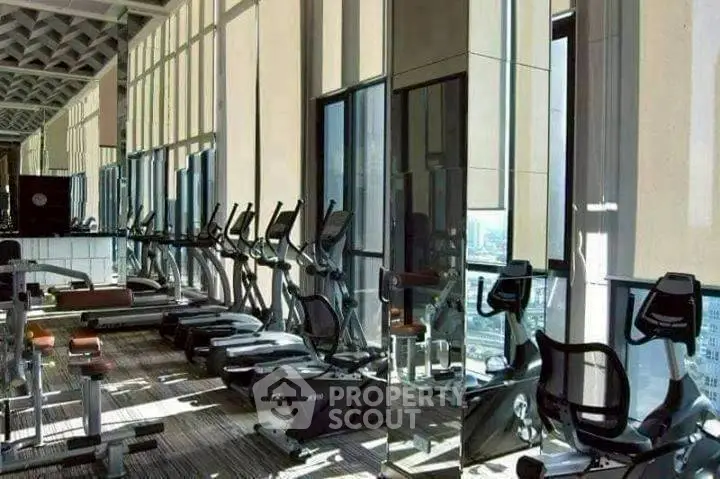 Luxurious high-rise gym with modern exercise equipment and panoramic city views.