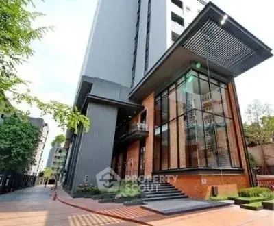 Modern high-rise building with sleek architectural design and glass facade