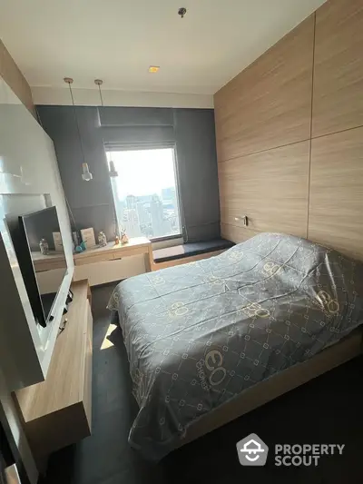 Modern bedroom with large window offering city views, sleek built-in wooden wardrobes, and a cozy bed, perfect for urban living.