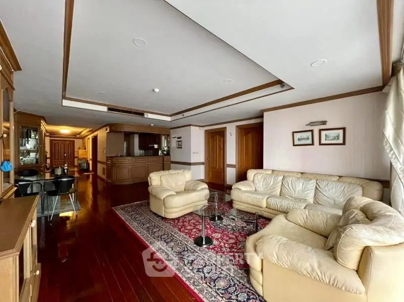 Spacious living room with elegant wooden flooring and luxurious leather sofas