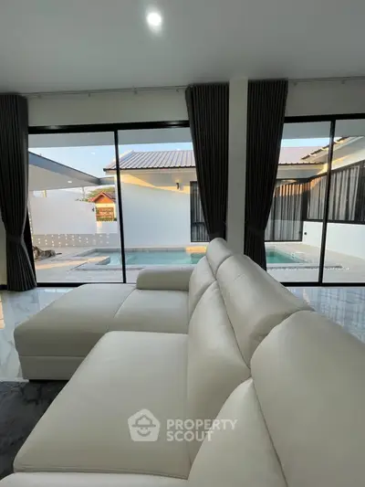 Luxurious living room with pool view and modern white sofa