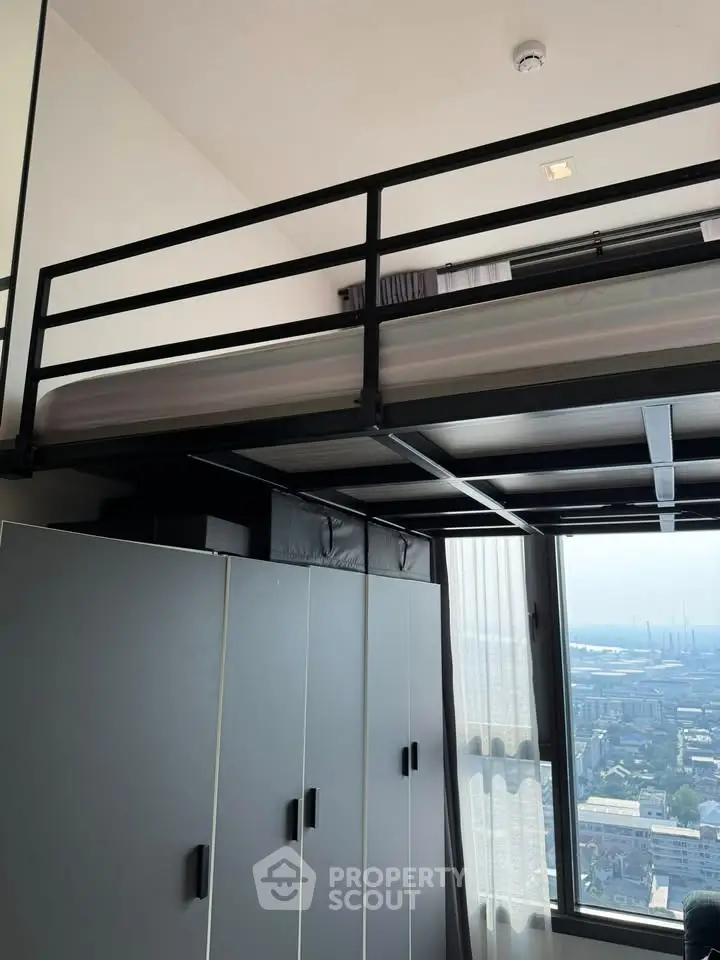Modern loft bedroom with city view and sleek storage solutions.