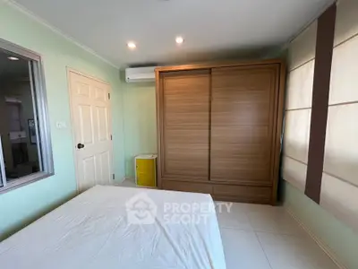 Spacious bedroom with modern wardrobe and air conditioning in a cozy apartment.