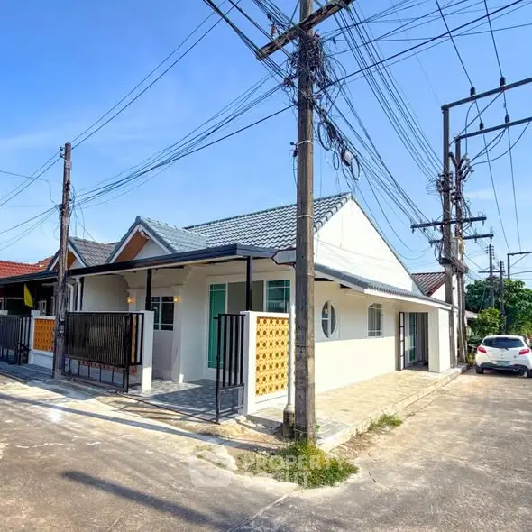 Charming single-story home with modern exterior and spacious driveway in a quiet neighborhood.