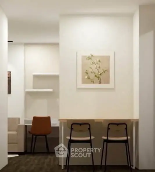 Modern study area with minimalist decor and stylish seating in a contemporary apartment.