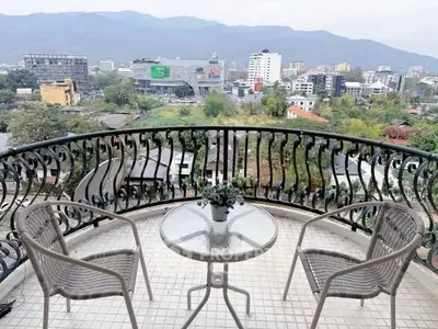 Charming balcony with stunning city and mountain views, perfect for relaxation and enjoying the scenery.