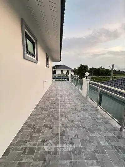 Spacious balcony with modern railing and scenic view in a contemporary home