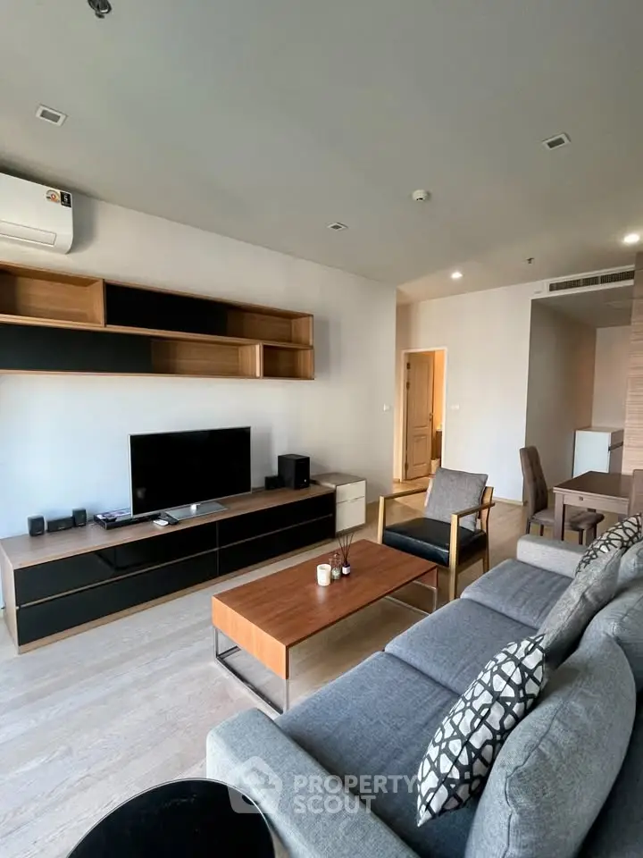 Modern living room with stylish furniture and entertainment center in a contemporary apartment.