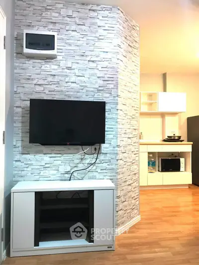 Modern living room with TV and stylish stone accent wall