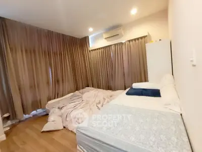 Cozy bedroom with two beds and soft lighting, perfect for relaxation and comfort.