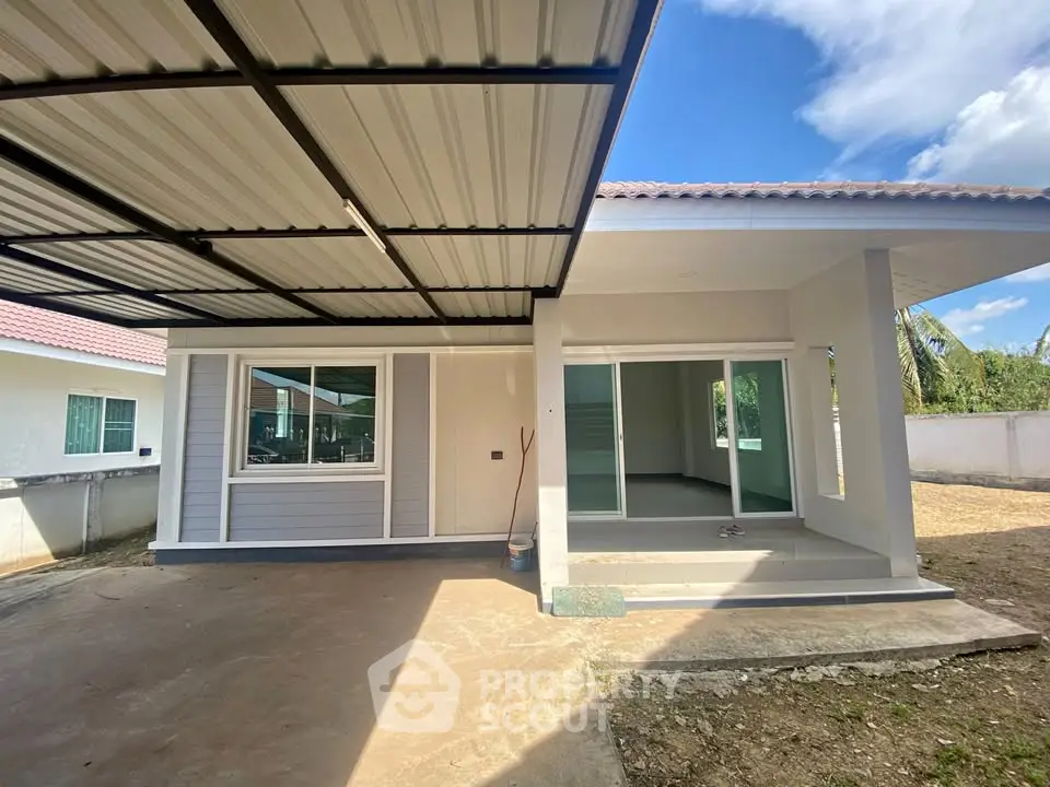 Modern single-story home with covered patio and sliding glass doors, ideal for family living.
