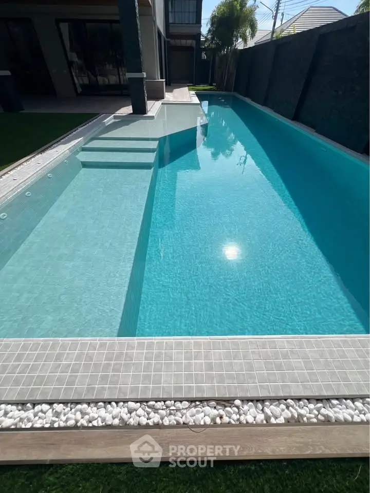 Luxurious modern backyard with sparkling swimming pool and elegant design