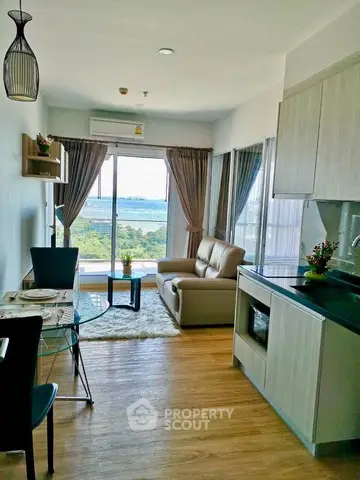 Modern living room with ocean view, stylish furniture, and open layout