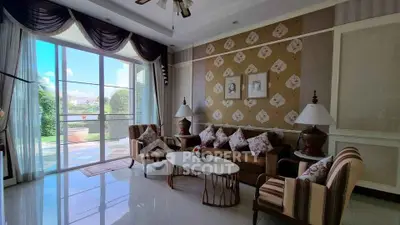 Elegant living room with stylish decor and large windows overlooking garden
