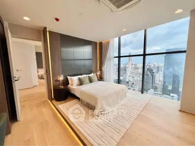 Luxurious bedroom with stunning city view and modern decor in high-rise apartment.