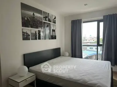 Modern bedroom with city view, featuring stylish decor and ample natural light.