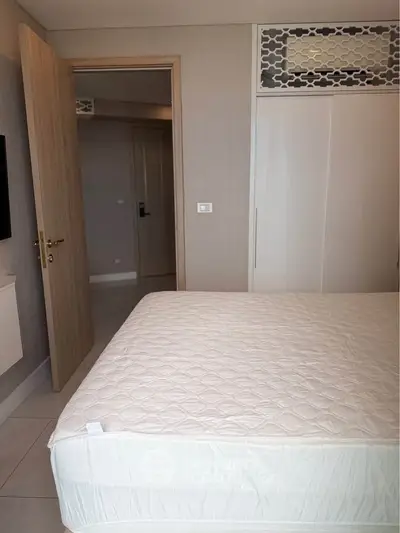Modern bedroom with stylish decor and built-in wardrobe, perfect for urban living.