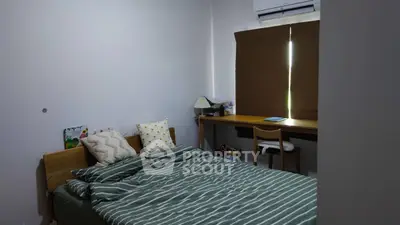 Cozy bedroom with modern decor and natural light, perfect for relaxation and comfort.