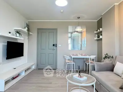 Modern living room with stylish decor and dining area, featuring neutral tones and sleek furniture.