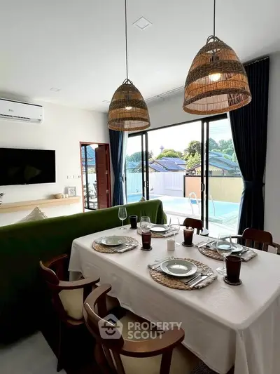 Charming dining area with elegant table setting and pool view, perfect for entertaining guests.