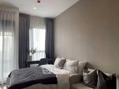 Modern bedroom with cozy bed and elegant curtains, perfect for relaxation.