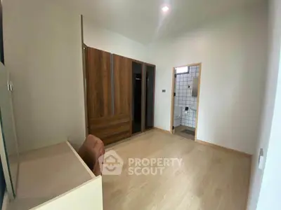 Spacious bedroom with wooden wardrobe and attached bathroom