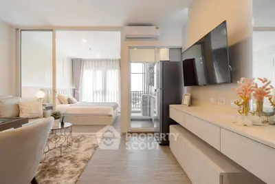 Modern open-plan living room with stylish decor and bedroom view