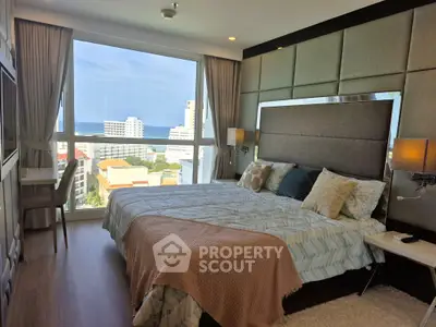 Luxurious bedroom with stunning ocean view and modern decor in high-rise apartment.