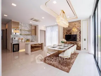 Luxurious open-plan living and dining area with elegant decor and modern lighting.