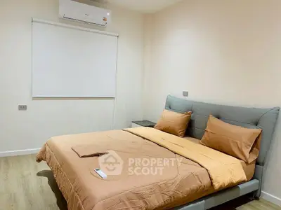 Modern bedroom with stylish bed and air conditioning unit, perfect for comfort and relaxation.