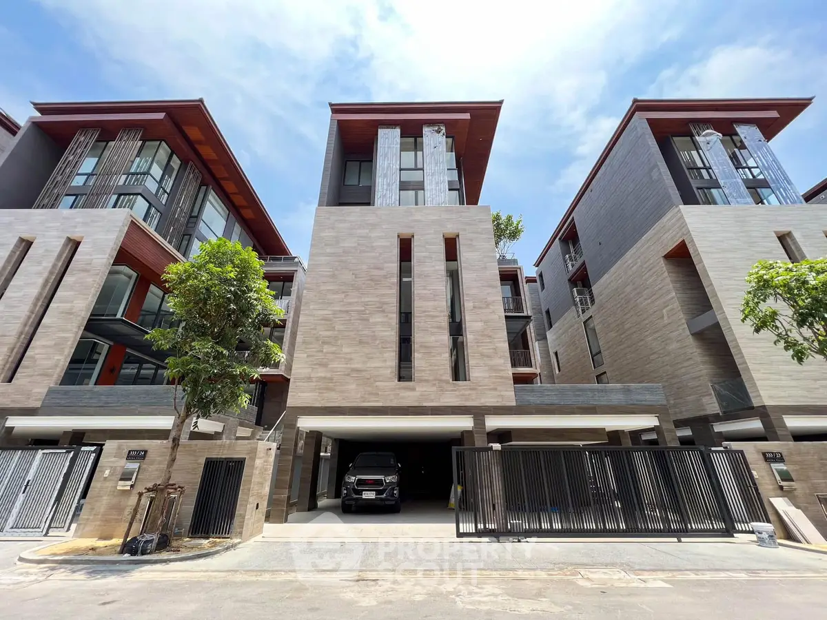 Modern multi-story residential building with sleek design and spacious garage.