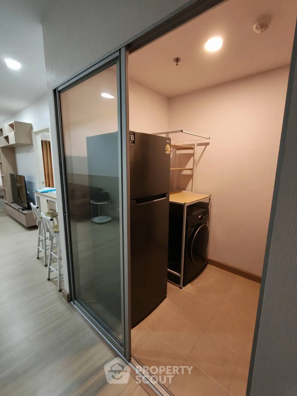 Modern apartment interior with sleek kitchen and laundry area