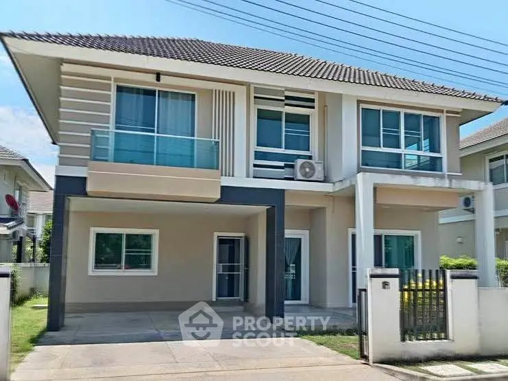 Modern two-story house with driveway and manicured lawn in suburban neighborhood.