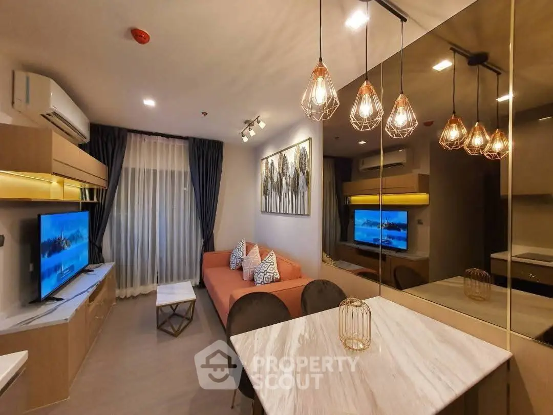 Modern living room with stylish lighting and cozy seating area, perfect for relaxation and entertainment.