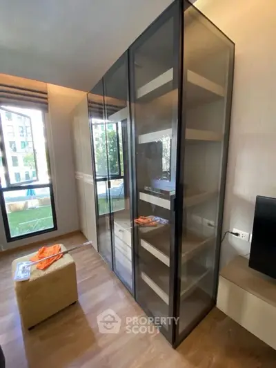 Modern living room with glass cabinet and large window view