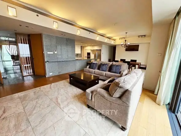 Spacious open-plan living room with modern kitchen and elegant decor