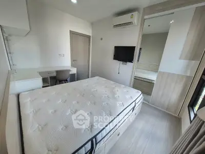 Modern bedroom with sleek design, featuring a comfortable bed, built-in wardrobe, and wall-mounted TV.