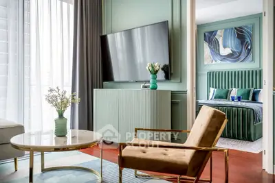 Stylish modern living room with elegant decor and a glimpse of a luxurious bedroom.