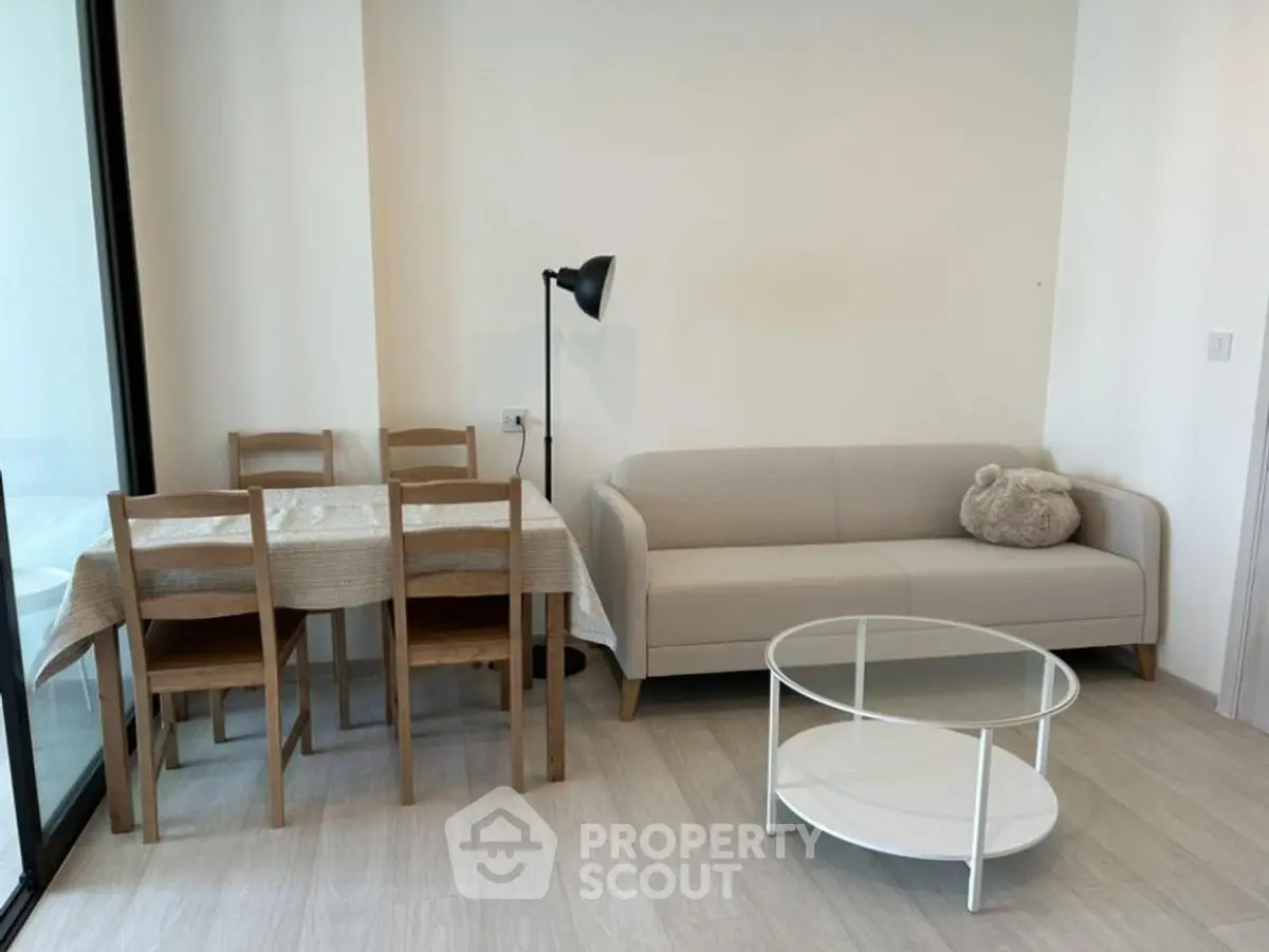 Modern living room with cozy sofa, dining table, and stylish decor