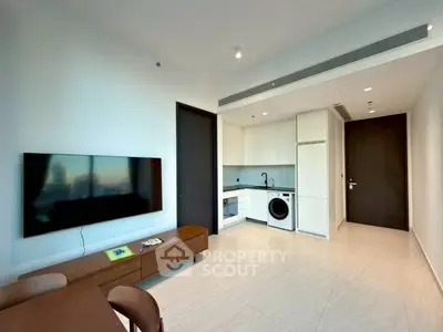 Modern living room with sleek furniture and built-in kitchen appliances.