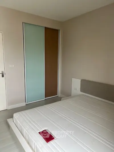 Modern minimalist bedroom with sliding door closet and comfortable bed