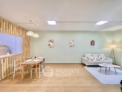 Spacious open-plan living and dining area with modern decor and natural light.