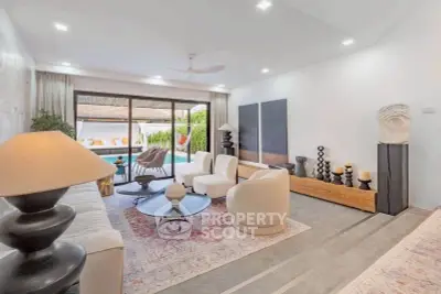 Luxurious living room with modern decor and pool view, perfect for relaxation.