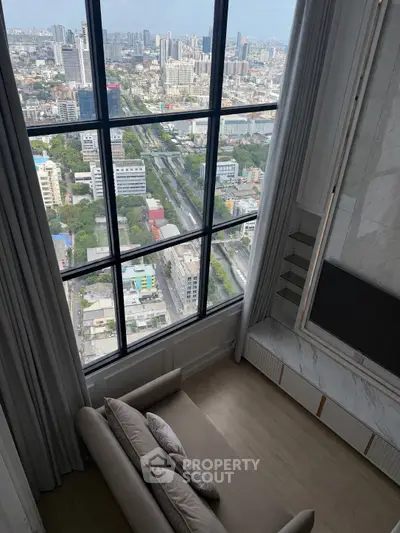 Luxurious high-rise apartment with stunning city view from large windows and elegant interior design.