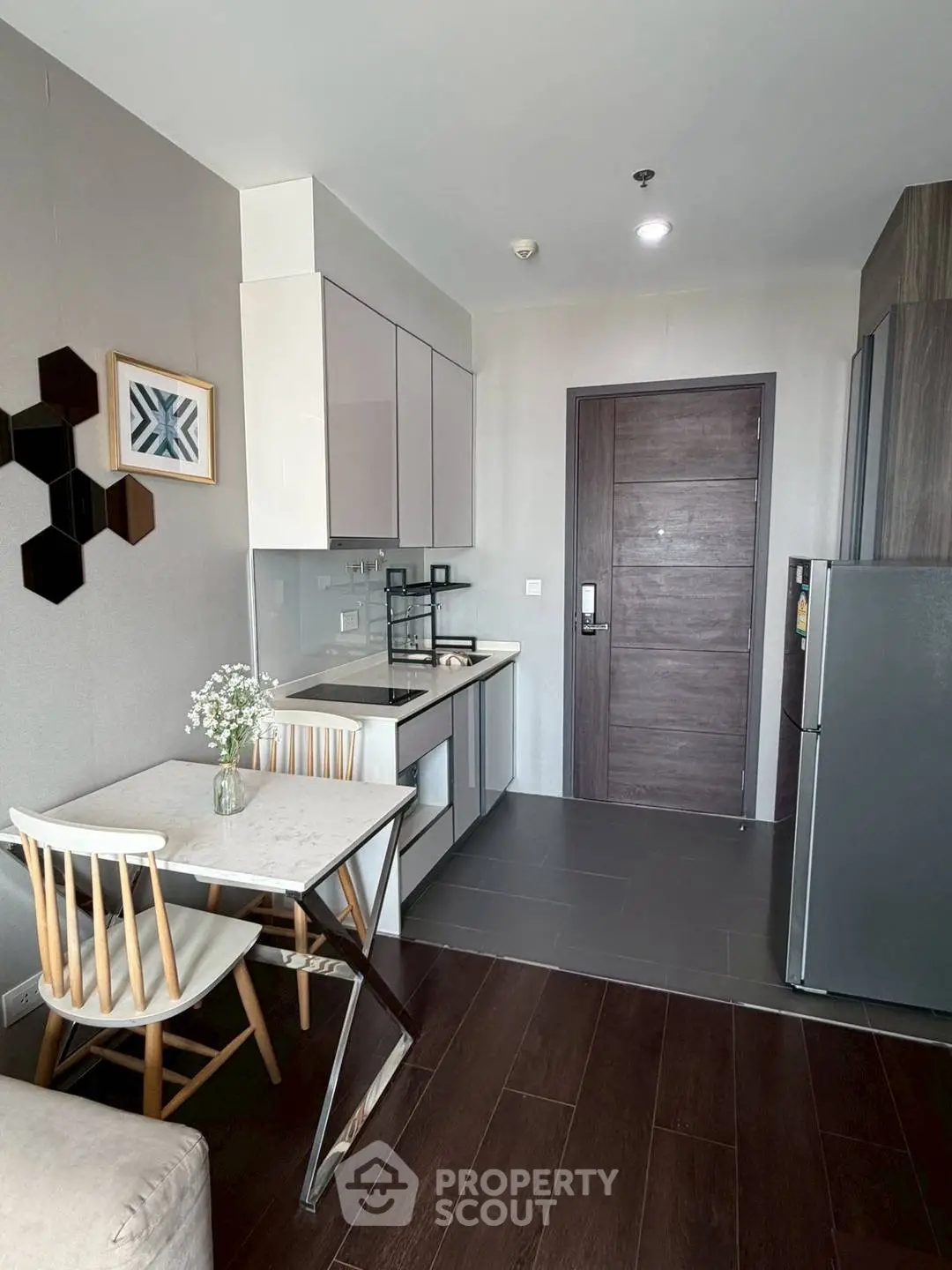 Modern kitchen with sleek cabinetry and dining area in stylish apartment
