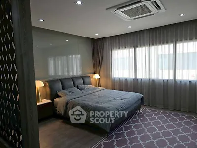 Luxurious bedroom with modern decor and ample natural light