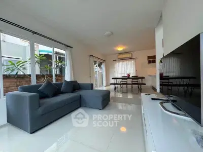 Spacious modern living room with sleek furniture and large windows for natural light.