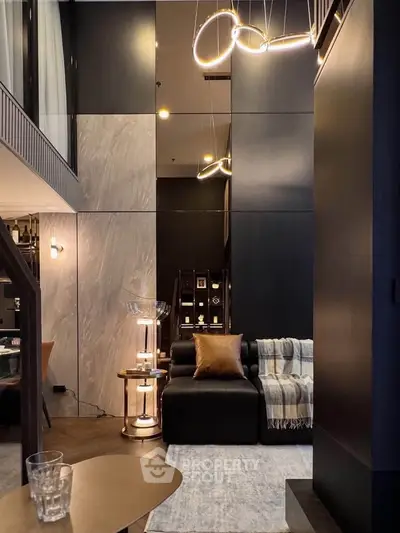 Luxurious modern living room with high ceilings and elegant lighting in a stylish apartment.